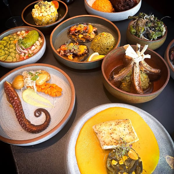 An overhead view of a table laden with various gourmet dishes, including seafood, meats, and rice.