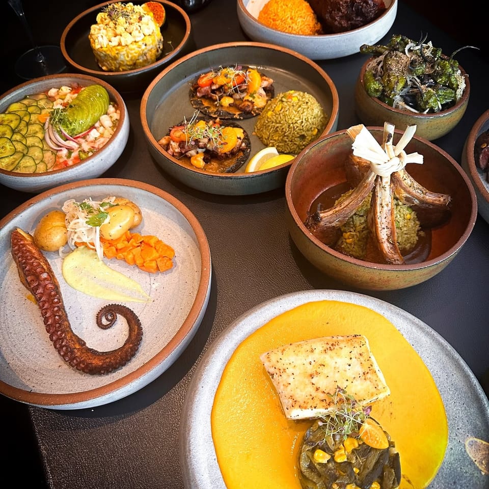 An overhead view of a table laden with various gourmet dishes, including seafood, meats, and rice.